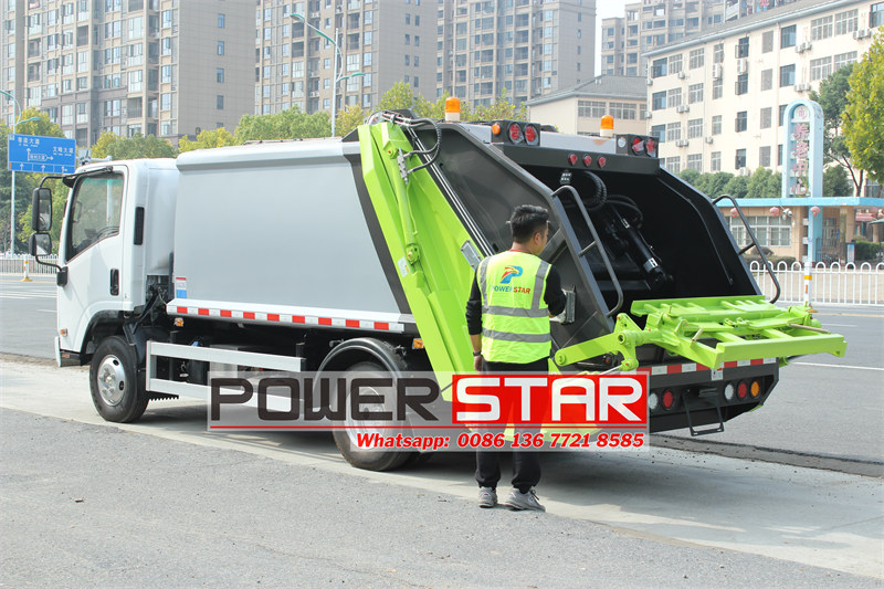 ISUZU new NPR rear loader compactor truck working